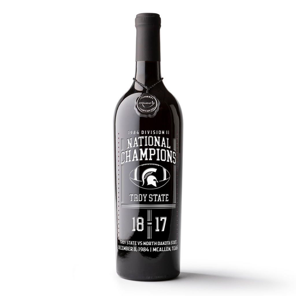 Mano's Wine etched wine bottle celebrating Troy University 1984 Football Champions with black and white design.