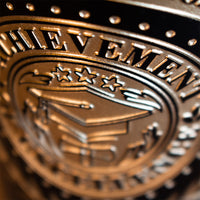 Close up of Achievement and Graduation cap deep etched on Graduation Laurel Etched Wine bottle