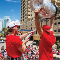 Florida Panthers hockey players celebrating their Stanley Cup championship hoisting the trophy and spraying team bubbly wine from Mano's Wine
