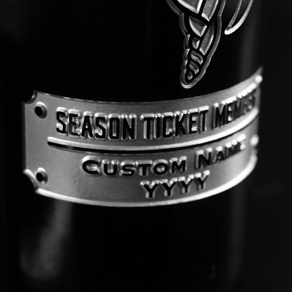 Close up deep etched wine bottle commemorating Minnesota Vikings fan season ticket holder