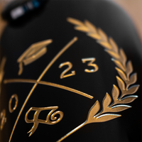 Close up of Custom Graduation Year Etched Wine bottle featuring graduation cap, graduation year, and diploma